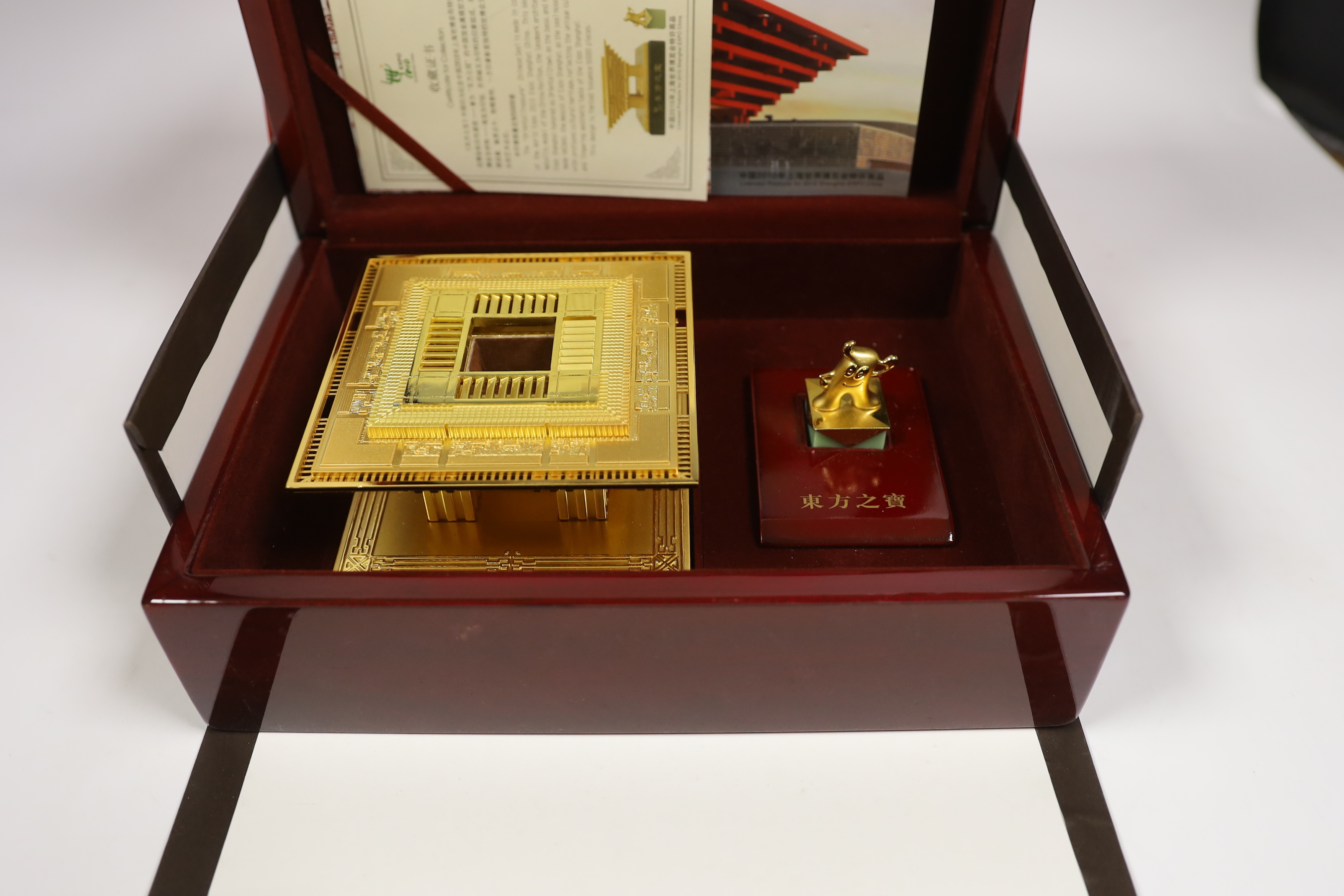 A cased Chinese Shanghai Expo 2010 model in gilt metal, 10cm high